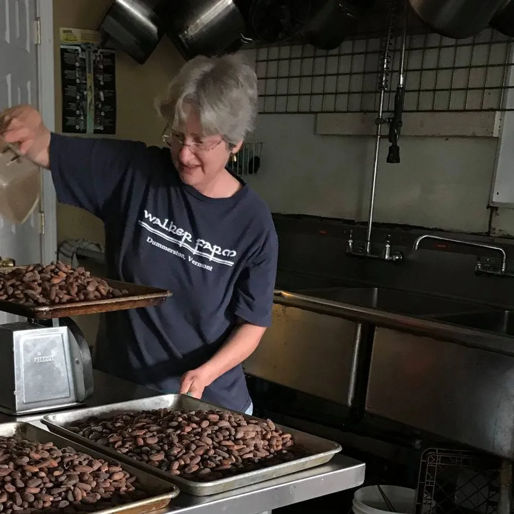 Dev spreading roasted beans across sheet trays in the Shoreline kitchen.