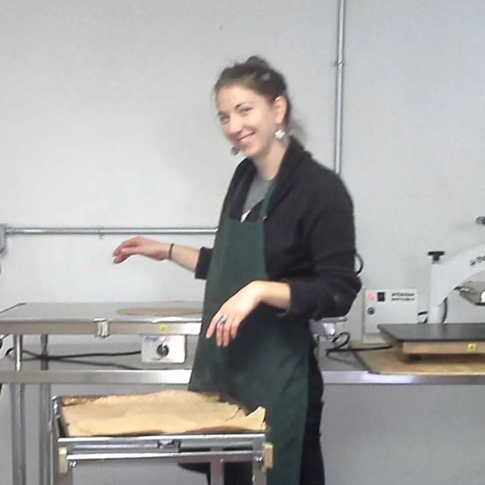 Jules laying out a tray of dough beside the sheeter.