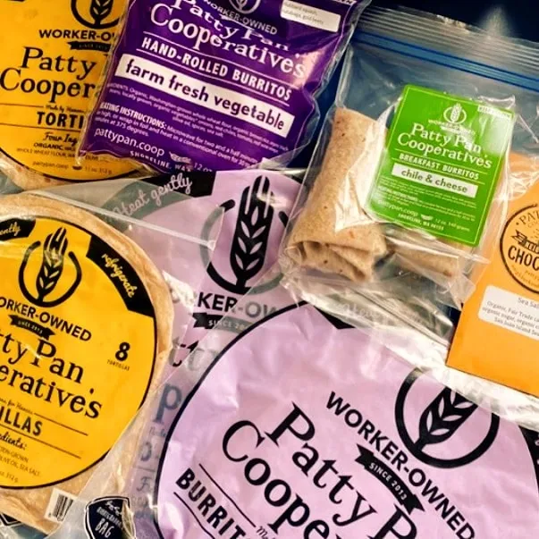Retail packages of Patty Pan burritos, tortillas and tamales laid out together.